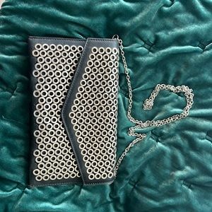 Vegan leather clutch with metal detailing